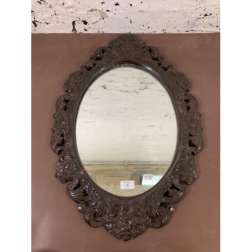 12 - A 19th century carved mahogany framed oval wall mirror - approx. 68cm high x 46cm wide