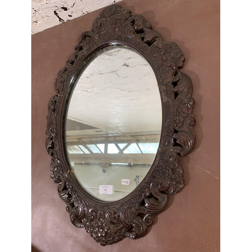 12 - A 19th century carved mahogany framed oval wall mirror - approx. 68cm high x 46cm wide