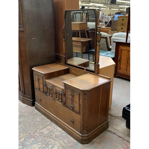 124 - A mid 20th century Crown AY Furniture carved oak linenfold two piece bedroom suite comprising double... 