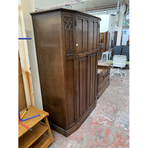 124 - A mid 20th century Crown AY Furniture carved oak linenfold two piece bedroom suite comprising double... 