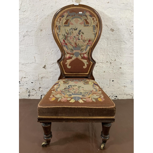 13 - A 19th century mahogany framed and tapestry upholstered nursing chair on brass castors stamped 