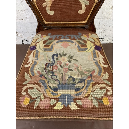 13 - A 19th century mahogany framed and tapestry upholstered nursing chair on brass castors stamped 