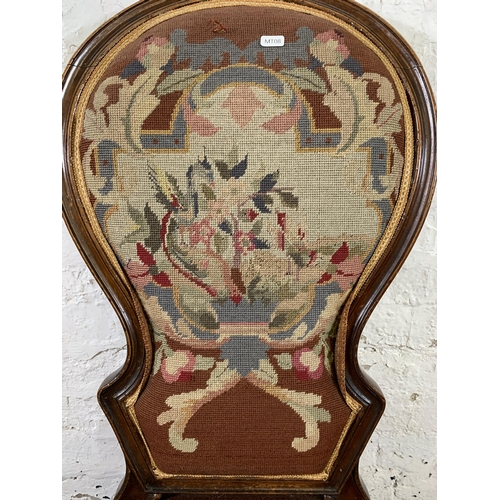 13 - A 19th century mahogany framed and tapestry upholstered nursing chair on brass castors stamped 