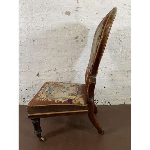 13 - A 19th century mahogany framed and tapestry upholstered nursing chair on brass castors stamped 