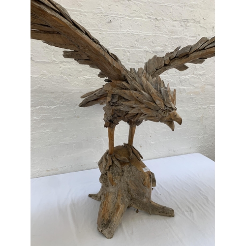 131 - A driftwood eagle sculpture - approx. 103cm high x 122cm wide