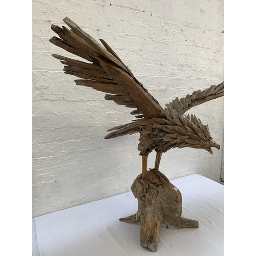 131 - A driftwood eagle sculpture - approx. 103cm high x 122cm wide