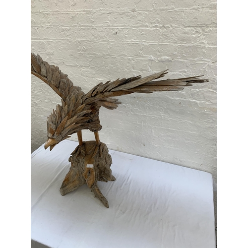 131 - A driftwood eagle sculpture - approx. 103cm high x 122cm wide