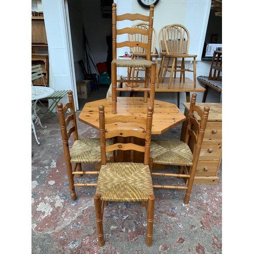 133 - A pine octagonal dining table and four rush seated chairs