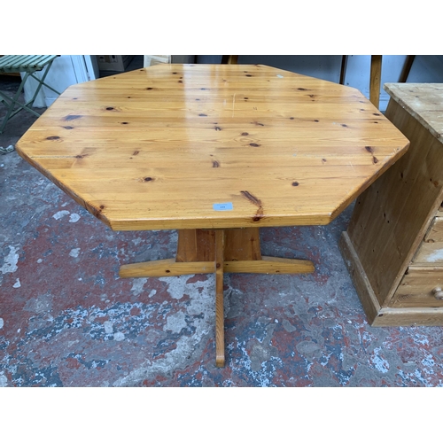 133 - A pine octagonal dining table and four rush seated chairs