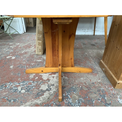 133 - A pine octagonal dining table and four rush seated chairs