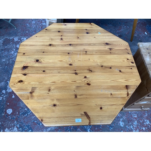 133 - A pine octagonal dining table and four rush seated chairs