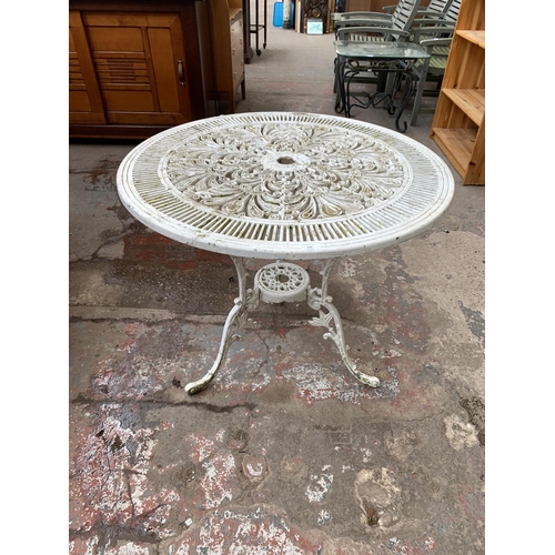 135 - A Victorian style white painted cast metal circular patio table - approx. 70cm high x 80cm diameter