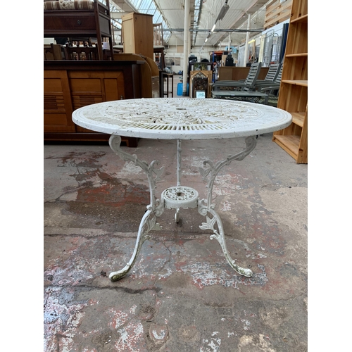 135 - A Victorian style white painted cast metal circular patio table - approx. 70cm high x 80cm diameter