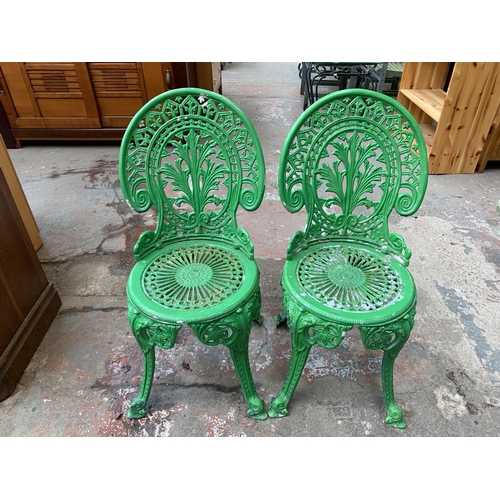 136 - A Victorian style green painted cast metal three piece patio set - table approx. 62cm high x 66cm di... 