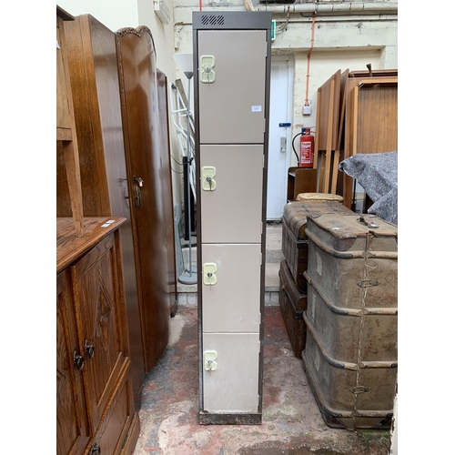 140 - A brown metal four door lockable cabinet - approx. 180cm high x 30cm wide x 45cm deep