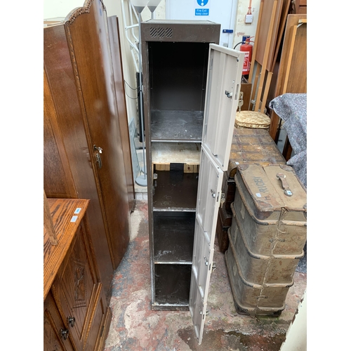 140 - A brown metal four door lockable cabinet - approx. 180cm high x 30cm wide x 45cm deep