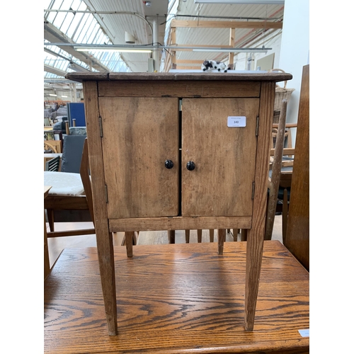 143 - An early 20th century pine two door side cabinet