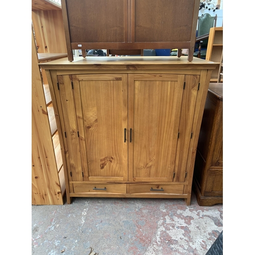 143 - An early 20th century pine two door side cabinet