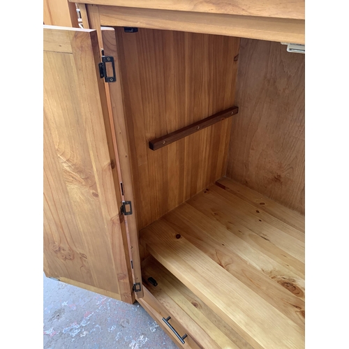 145 - A modern pine two door TV cabinet - approx. 127cm high x 120cm wide x 69cm deep