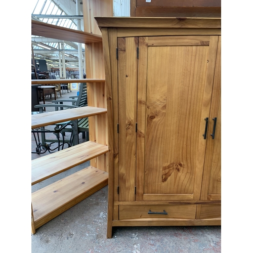 145 - A modern pine two door TV cabinet - approx. 127cm high x 120cm wide x 69cm deep