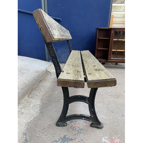 150 - A late 19th/early 20th century Needham Stockport cast iron and wooden slatted garden bench - approx.... 