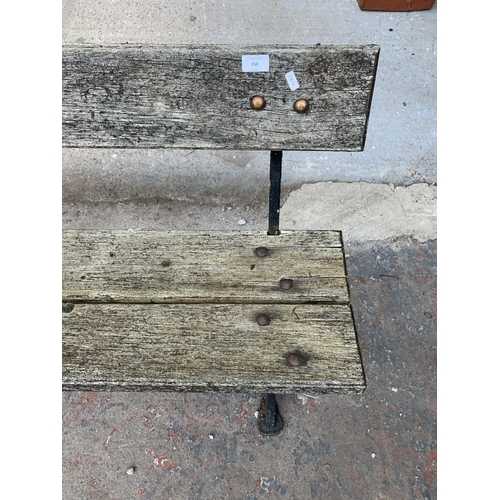 150 - A late 19th/early 20th century Needham Stockport cast iron and wooden slatted garden bench - approx.... 