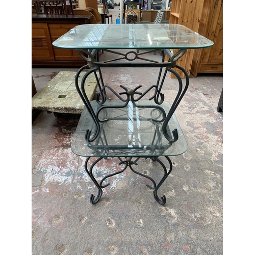 151 - A pair of wrought metal and glass top side tables - approx. 53cm high x 66cm wide x 66cm deep