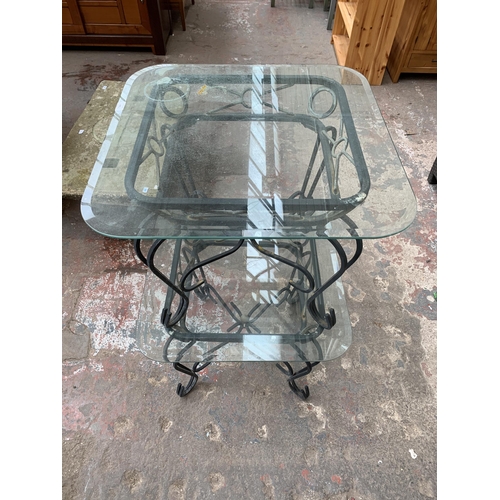 151 - A pair of wrought metal and glass top side tables - approx. 53cm high x 66cm wide x 66cm deep