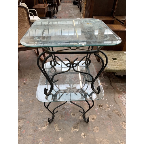 151 - A pair of wrought metal and glass top side tables - approx. 53cm high x 66cm wide x 66cm deep