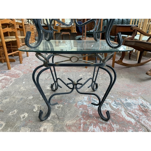 151 - A pair of wrought metal and glass top side tables - approx. 53cm high x 66cm wide x 66cm deep