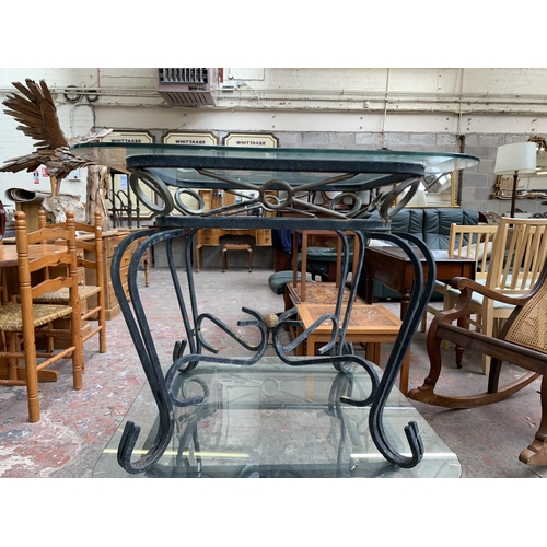 151 - A pair of wrought metal and glass top side tables - approx. 53cm high x 66cm wide x 66cm deep