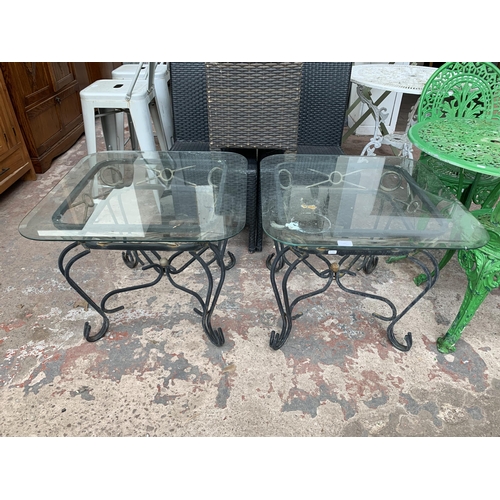 151 - A pair of wrought metal and glass top side tables - approx. 53cm high x 66cm wide x 66cm deep