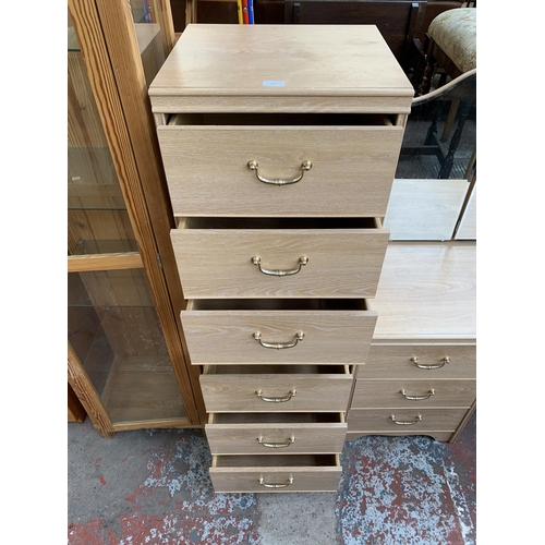 156 - An Alstons limed oak effect three piece bedroom suite comprising dressing table with mirror and two ... 