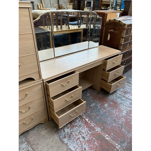 156 - An Alstons limed oak effect three piece bedroom suite comprising dressing table with mirror and two ... 