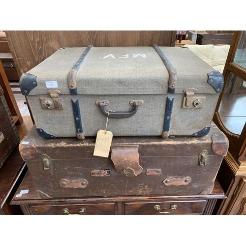 159 - Two travel trunks, one early 20th century brown leather and fibreboard and one mid 20th century fabr... 