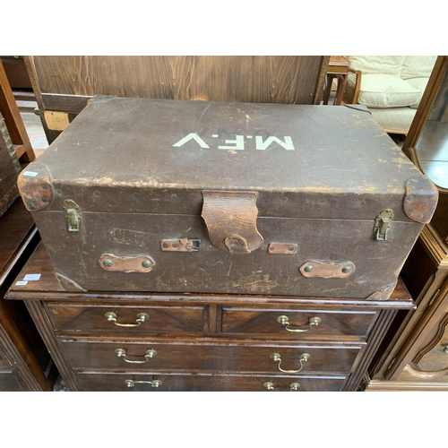 159 - Two travel trunks, one early 20th century brown leather and fibreboard and one mid 20th century fabr... 