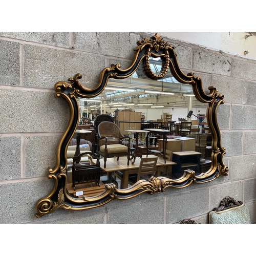 16 - A Rococo style black and gilt framed overmantel mirror - approx. 107cm high x 146cm wide