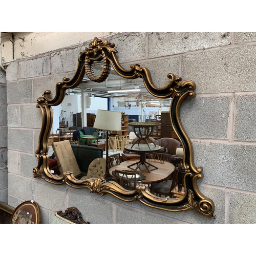 16 - A Rococo style black and gilt framed overmantel mirror - approx. 107cm high x 146cm wide