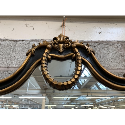 16 - A Rococo style black and gilt framed overmantel mirror - approx. 107cm high x 146cm wide