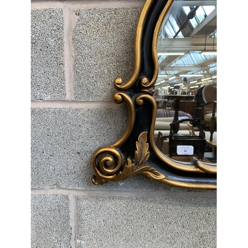 16 - A Rococo style black and gilt framed overmantel mirror - approx. 107cm high x 146cm wide