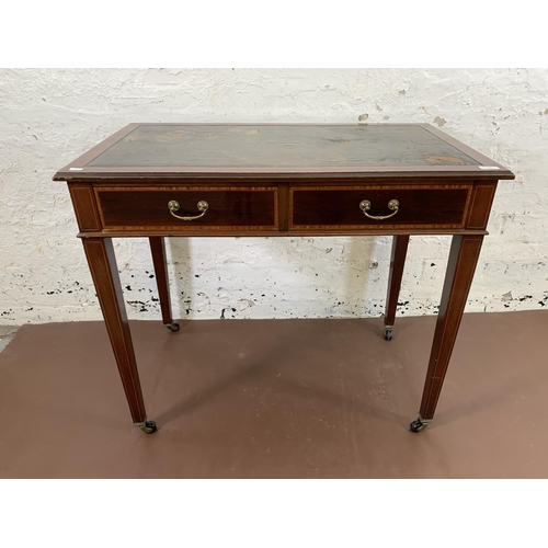 170 - An Edwardian inlaid mahogany two drawer writing table with black leather insert and tapering support... 