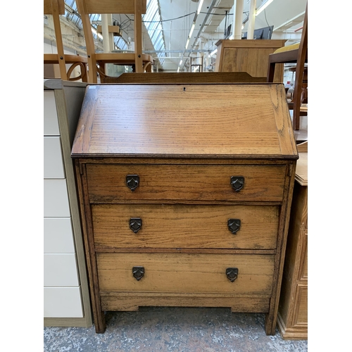 172 - An early 20th century oak bureau - approx. 106cm high x 76cm wide x 42cm deep