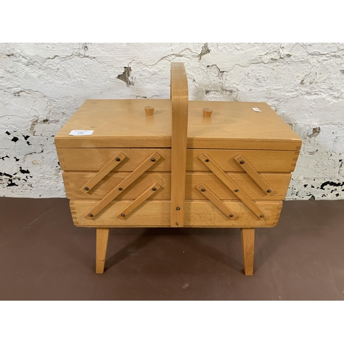 173 - A mid 20th century beech and plywood concertina sewing box - approx. 45cm high x 42cm wide x 21cm de... 