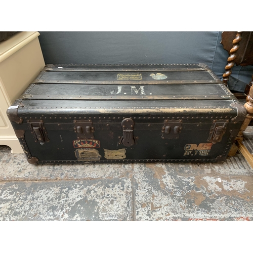 179 - An early 20th century black painted fibreboard travel trunk - approx. 35cm high x 100cm wide x 53cm ... 