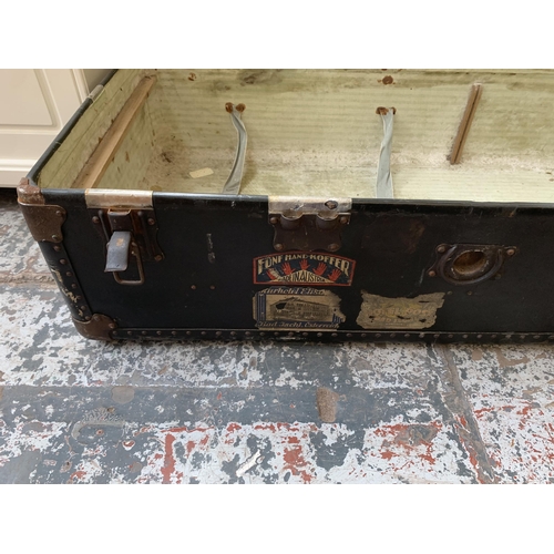 179 - An early 20th century black painted fibreboard travel trunk - approx. 35cm high x 100cm wide x 53cm ... 