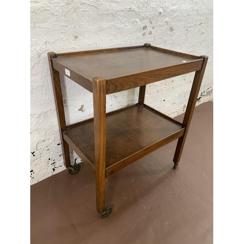 181 - An early/mid 20th century oak two tier tea trolley