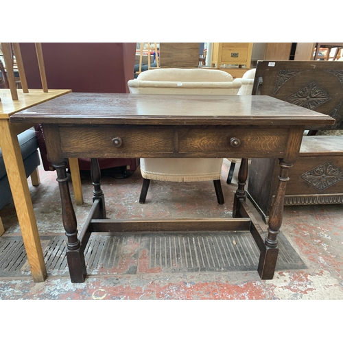 184 - An early/mid 20th century oak two drawer console table - approx. 76cm high x 107cm wide x 60cm deep