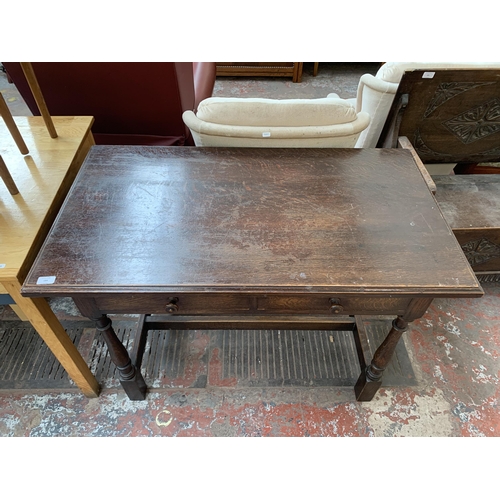 184 - An early/mid 20th century oak two drawer console table - approx. 76cm high x 107cm wide x 60cm deep