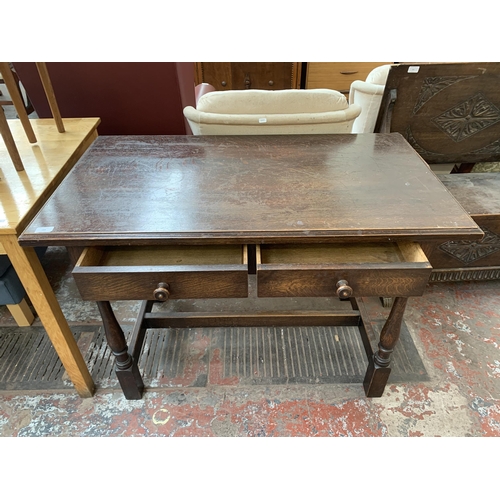 184 - An early/mid 20th century oak two drawer console table - approx. 76cm high x 107cm wide x 60cm deep