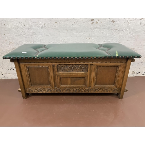 186 - An Old Charm carved oak and green vinyl upholstered blanket box - approx. 50cm high x 123cm wide x 4... 